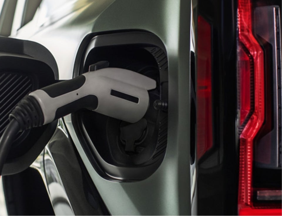 Close up of charging port with charger plugged in on a GMC Hummer EV SUV - Dossett GMC Cadillac in HATTIESBURG MS
